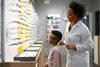 optician-helping-child-with-glasses