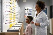 optician-helping-child-with-glasses